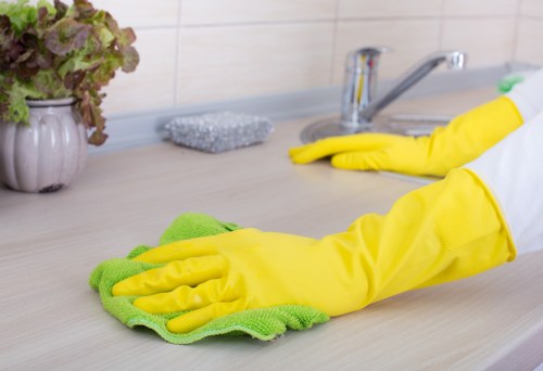 Professional house cleaner tidying a living room in Sandgate